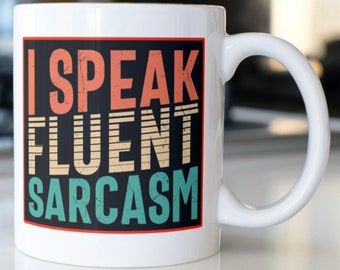 May include: White ceramic mug with a black rectangle featuring the text "I SPEAK FLUENT SARCASM" in a retro style font with colorful stripes.