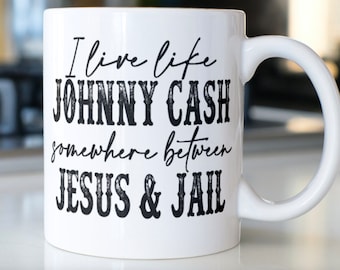 Funny Sarcastic Coffee mug stating “I live like Johnny Cash, somewhere between JESUS & Jail”