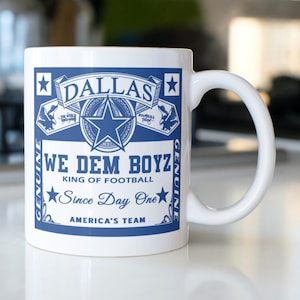 Dallas coffee mug stating, "Dallas WE DEM BOYZ   King of Football   Since day One   America's Team"