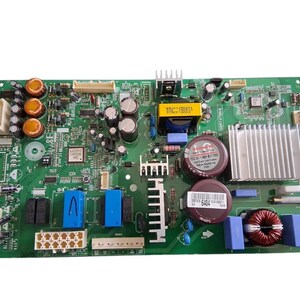 May include: A green circuit board with various electronic components, including capacitors, resistors, and integrated circuits. The board features a silver heat sink, blue and yellow components, and multiple connectors. The components are arranged on a rectangular board.
