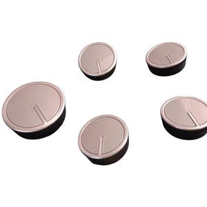 May include: Five silver-colored control knobs with a black base are arranged against a white background. Each knob has a silver top with a vertical groove. The knobs are likely for a stove or appliance.