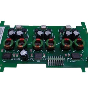 May include: A green circuit board with various electronic components, including black capacitors, red and gold coils, and integrated circuits. The board has a rectangular shape with several connectors and a barcode label.
