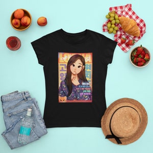 May include: Black women's t-shirt featuring a colorful illustration of a woman with long black hair, wearing a patterned shirt and holding a cat. The illustration is surrounded by a colorful frame with Korean text. The text "Hey you!" is written in English in a speech bubble.