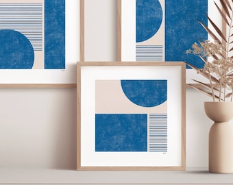 May include: Three framed abstract art prints with a minimalist design featuring geometric shapes in shades of blue and beige.