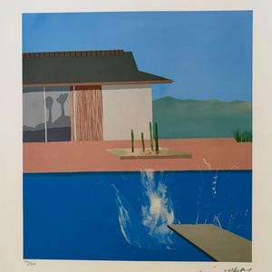 May include: A print of a mid-century modern scene with a blue pool and a house. The artwork features a diving board, splashes in the water, and a clear blue sky. The print is numbered 40/200.