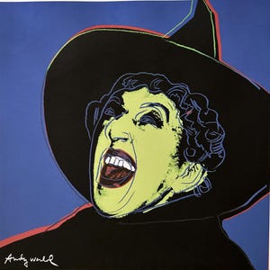 May include: Pop art print of a green-skinned witch with a black hat and open mouth, set against a blue background. The artwork is signed "Andy Warhol" in the lower left corner.