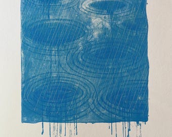 May include: Blue and white art print depicting a rainy scene. The artwork features concentric circles and diagonal lines suggesting raindrops. The print has a square format with drips at the bottom and is numbered 192/200. Signed by the artist.