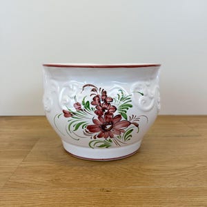 May include: A set of three ceramic mugs with a speckled, matte finish. The mugs are in shades of cream, light gray, and dark gray. Each mug has a simple, minimalist design, perfect for coffee or tea.