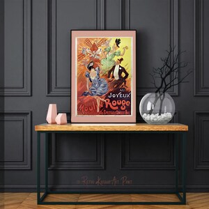 May include: A vintage poster advertising the Moulin Rouge cabaret in Paris, France. The poster features a red and orange background with a group of women in colorful costumes. The text on the poster reads "Au Joyeux Moulin Rouge."