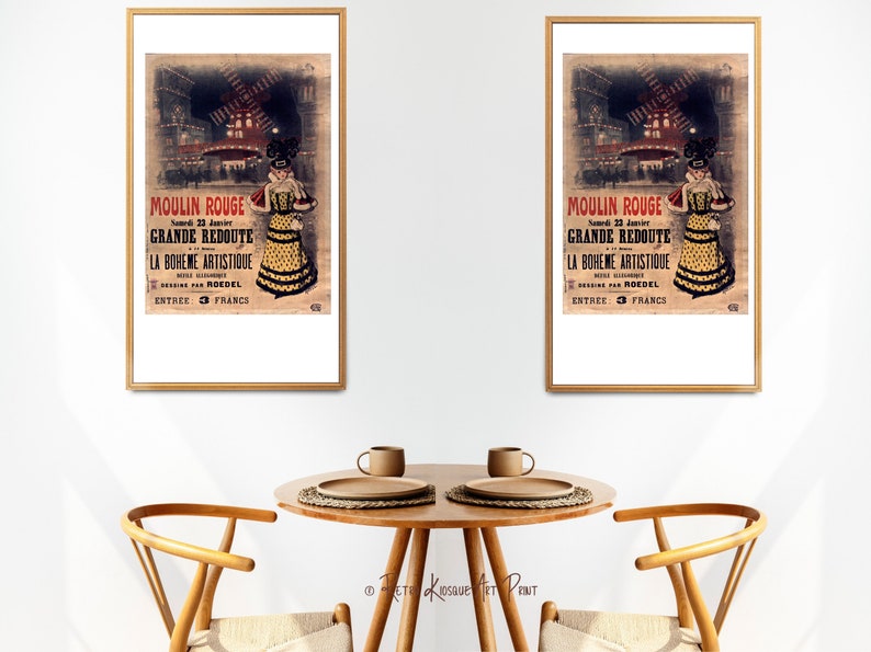 May include: Two framed vintage posters advertising a Moulin Rouge event. The posters feature a woman in a yellow and black dress with a red feather boa. The text on the posters reads "Moulin Rouge", "Grande Redoute", "La Boheme Artistique", "Roedel", and "Entree: 3 Francs".