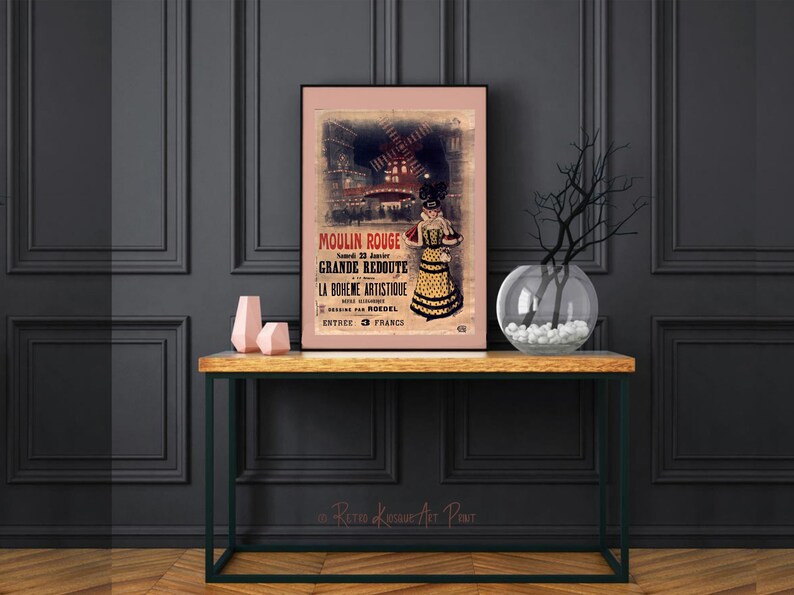 May include: A vintage poster advertising the Moulin Rouge in Paris, France. The poster features a woman in a yellow and black dress, a windmill, and the text "Moulin Rouge, Grande Redoute, La Boh&egrave;me Artistique, Entr&eacute;e 3 Francs".