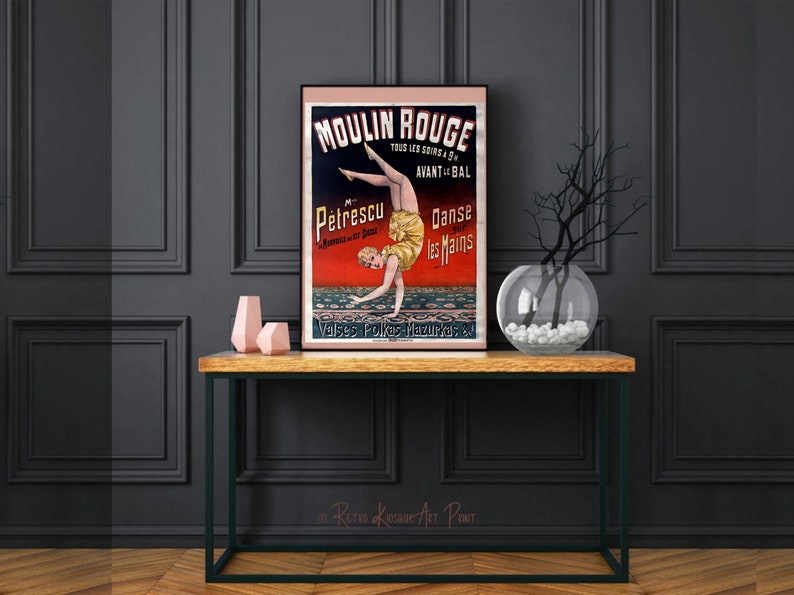 May include: Vintage Moulin Rouge poster featuring a woman in a yellow and red costume performing a handstand. The poster is printed on paper and has a red, black, and white color scheme. The text on the poster reads "Moulin Rouge", "Petrescu", "Danse les Mains", and "Valses Polkas Mazurkas".