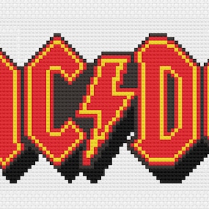 May include: Cross-stitch design of the band name "AC/DC" in red, outlined in yellow, with a black shadow effect. A yellow lightning bolt replaces the forward slash. The design is on a white background.