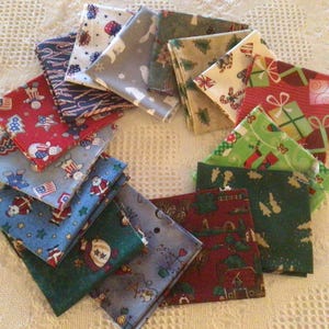 May include: A collection of 14 fabric squares with various Christmas-themed patterns, including red, green, blue, white, and brown colors. The squares are arranged in a circle, with the edges overlapping.
