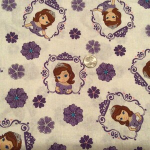 May include: White fabric with a repeating pattern of a cartoon princess in a purple dress, framed in ornate purple borders. Purple flowers and small pink hearts are scattered across the background.