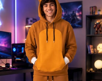 May include: A brown hooded sweatshirt featuring a large yellow front panel, a kangaroo pocket, and pointed animal ears on the hood, paired with matching brown sweatpants. The hoodie has black drawstrings and white ribbed cuffs at the wrists.