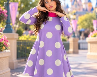 May include: A long-sleeved dress in a vibrant purple hue featuring large, cream-colored polka dots throughout. The garment includes a solid pink mock neck collar and a flared skirt silhouette that falls above the knee. The text AI generated model shown.