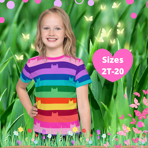 May include: A young girl wearing a rainbow striped t-shirt with a cat silhouette design. The shirt is available in sizes 2T-20. The image is set against a green grassy background with pink and white flowers.