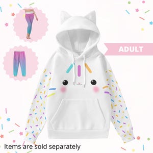 May include: White hooded sweatshirt with cat ears, a cartoon cat face, and colorful sprinkles on the sleeves. The word "ADULT" is displayed in pink. The text "Items are sold separately" is at the bottom.
