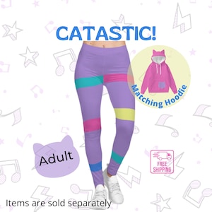 May include: Purple leggings with colourful stripes and a matching pink hoodie with cat ears. The leggings and hoodie have the text "Catastatic!" and "Matching Hoodie" on them. The text "Adult" is on a cat-shaped sticker. The text "Free Shipping" is on a sticker with a delivery truck.