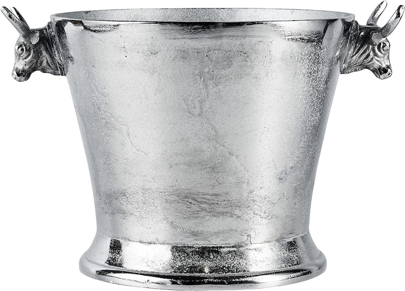 May include: Silver ice bucket with bull head handles. The bucket has a textured surface and a wide base.