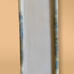 May include: A white frame with a blue and white patterned border. The frame is made of a thin, flexible material.