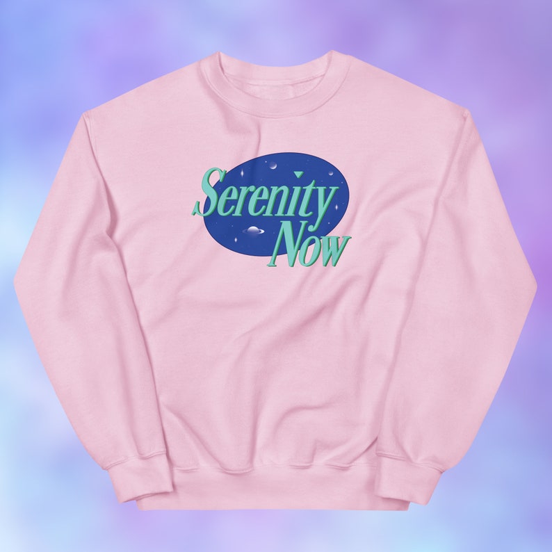 May include: Pink sweatshirt with a blue and green graphic of a space scene with the text "Serenity Now".