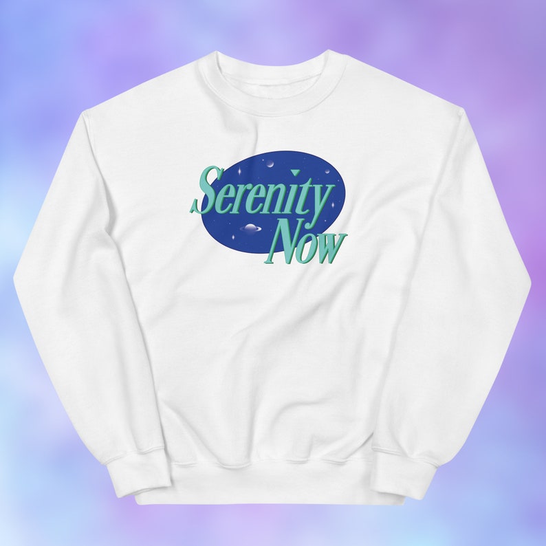May include: White sweatshirt with a blue and green graphic of a circle with the text "Serenity Now" inside.