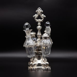 English Antique Cruet set With a Massive Silver Carrier Consisting a Salt Bottle and Oil Bottle With a Mustard Jar and Vinegar Bottle