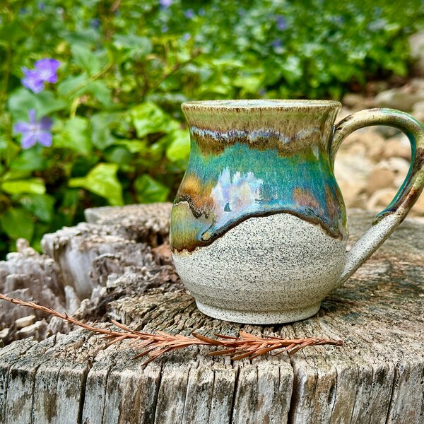 Wheel thrown mug with flowing glazes