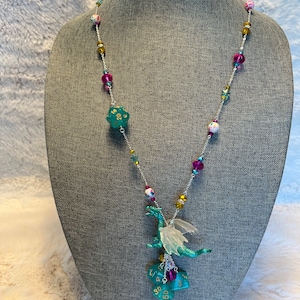 Dungeons and Dragons Necklace with d20, d8, d%, and d12 dice and green dragon