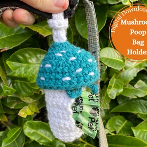 May include: A crocheted mushroom-shaped poop bag holder. The mushroom is teal with white dots and a white stem. The holder is attached to a black and green leash.