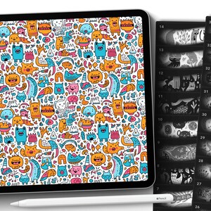 May include: A digital tablet displaying a colorful pattern of cartoon characters and animals. The tablet is next to a stack of black and white images of similar cartoon characters and animals.