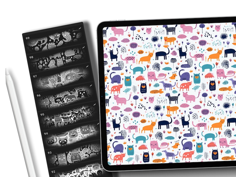May include: A digital tablet displaying a colorful pattern of cats, flowers, and geometric shapes. The pattern is on a white background. The tablet is on a white surface.