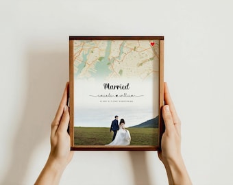 May include: A framed print with a map and a photo of a couple. The map has a red heart marking a location. The text on the print reads "Married" with the couple's names and wedding date.