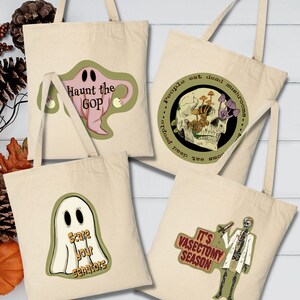 May include: Four beige canvas tote bags with Halloween-themed designs. One bag features a pink ghost with the text "Haunt the GOP." Another displays a skull with mushrooms and the text "People eat dead mushrooms." A third bag has a ghost with "Scare your senators." The last bag has a skeleton with "It's Vasectomy Season."