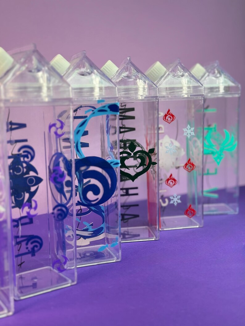 May include: A row of clear plastic water bottles with white caps. Each bottle has a different colorful graphic design on the front, including blue, green, and red symbols. The bottles are arranged on a purple surface.