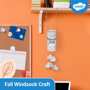 May include: A white cylindrical windsock craft with the text "Welcome Fall!" and leaf illustrations hangs from a gold string. Below, are several white leaf cutouts. The background is an orange wall with a corkboard and a shelf.