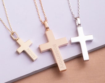 May include: Three gold, rose gold, and silver necklaces with cross pendants. The cross pendants are engraved with the names "Nova", "Rosemary", and no name on the silver cross.
