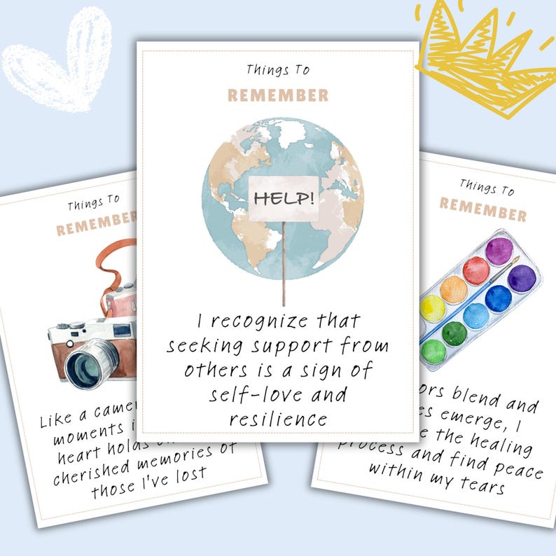 May include: Three printable cards with watercolor illustrations and text. The first card features a camera and the text "Like a camera, moments I heart hold... cherished memories of those I've lost". The second card features a globe with a sign that says "HELP!" and the text "I recognize that seeking support from others is a sign of self-love and resilience". The third card features a watercolor palette and the text "Colors blend and hues emerge, I process the healing and find peace within my tears".