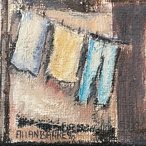 May include: A painting of a clothesline with three pieces of clothing hanging on it. The clothing is blue, yellow, and white. The painting is signed "Allan Barker" in the bottom right corner.