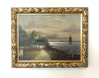 G. Engmann Landscape painting with motive of rural house at the ocean with sailboats and gloomy skies in beautiful gold wooden frame
