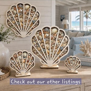 May include: A collection of four light-colored wooden shell-shaped frames filled with various small natural seashells. The set includes one large wall-mounted frame, one medium standing frame, and two small standing frames with the text Check out our other listings.