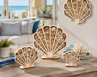 May include: A collection of four shell-shaped wooden frames filled with assorted small seashells. Three frames are freestanding on a wooden surface, while one larger frame is mounted on the wall. Each frame features a fan-like design.