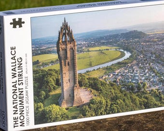 May include: A white box with a picture of the National Wallace Monument in Stirling, Scotland. The box is labeled "The National Wallace Monument Stirling 1000 piece jigsaw puzzle".