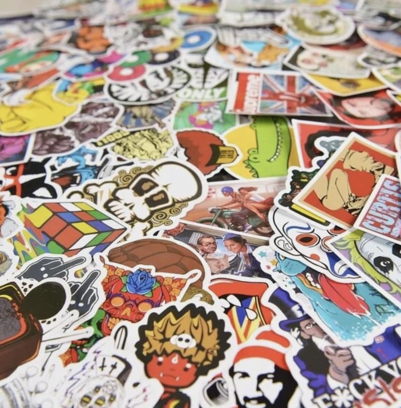May include: A collection of colorful stickers with various designs, including skulls, cartoon characters, and pop culture references. The stickers are of different shapes and sizes, with a variety of colors and images. Some stickers have text, and others feature illustrations.