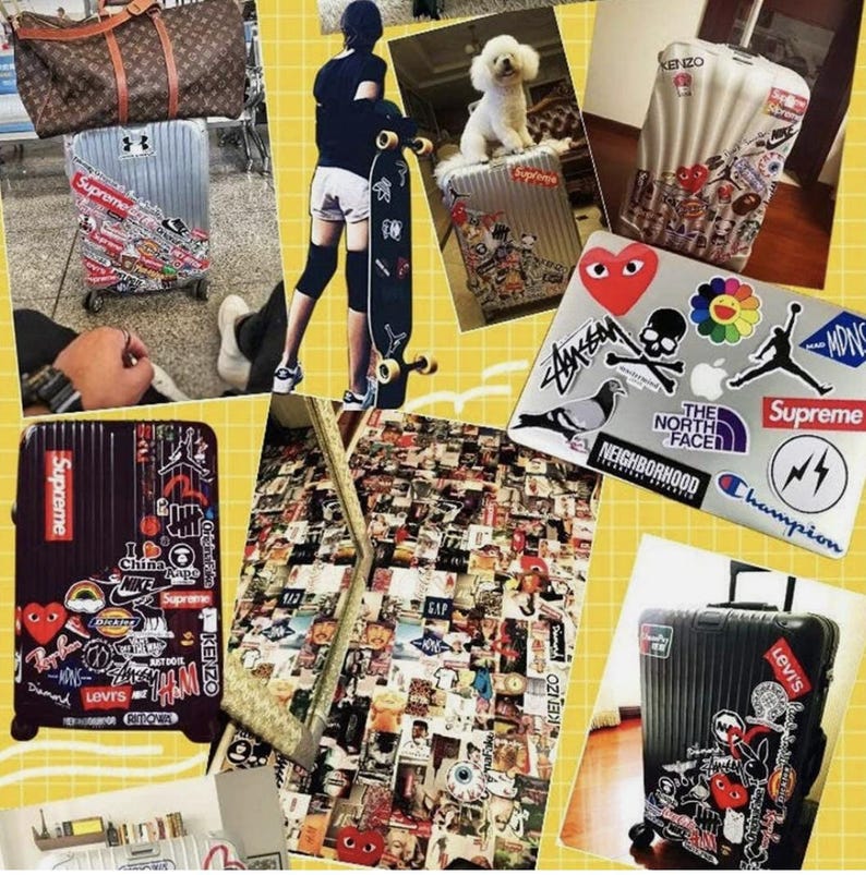 May include: Collection of luggage and accessories, including a brown duffel bag, a silver suitcase with Supreme stickers, and a black suitcase with various brand stickers. A laptop covered in stickers is also visible.