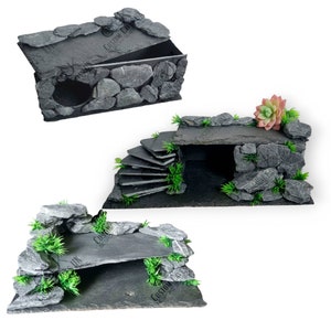 May include: Three different styles of reptile hideaways made from slate rock and artificial plants. The hideaways are designed for use in terrariums and are available in a variety of sizes.