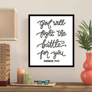 May include: Black and white framed print with the text "God will fight the battle for you" and the scripture reference "Exodus 14:14".