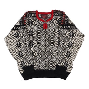 May include: Black and white patterned sweater with red trim and a zipper detail. The sweater has a traditional Scandinavian design.